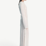 Model wearing a KABE SHOP INC Mirror dress in sheer white fabric with delicate silver embellishments and long sleeves.