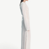 Model wearing a KABE SHOP INC Mirror dress in sheer white fabric with delicate silver embellishments and long sleeves.