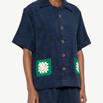 KABE SHOP INC navy organic cotton towelling boxy shirt with green and white handwoven crochet pocket detail