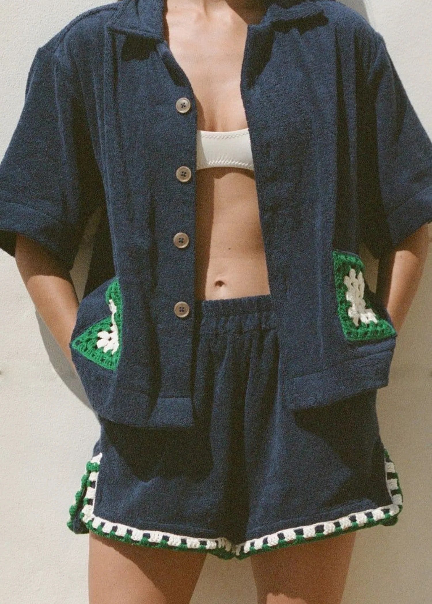 KABE SHOP INC navy organic cotton towelling boxy shirt with a handwoven green and white crochet pocket detail.