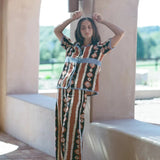 KABE SHOP INC Nera wide leg pants featuring a tribal ikat print in brown, black, and white, worn with matching top.