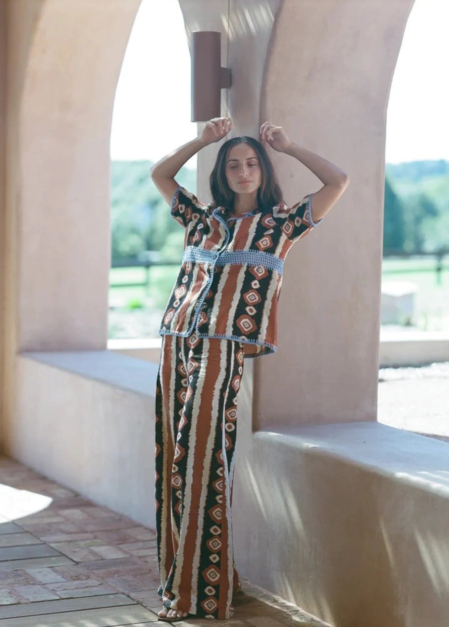 KABE SHOP INC Nera wide leg pants featuring a tribal ikat print in brown, black, and white, worn with matching top.