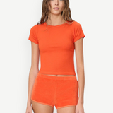 KABE SHOP INC Mini Track Short in bright orange terry cloth, featuring a slim fit and mini length on a model.