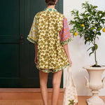 KABE SHOP INC Patty shirt with a yellow floral print and mixed pattern sleeves, worn with matching shorts.