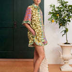 KABE SHOP INC Patty shirt featuring a vibrant multi-colored floral print, relaxed fit, and ruffled hem details.