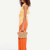 Model wearing KABE SHOP INC Pia Poplin Pant in fruit punch orange stripe with a matching yellow striped top