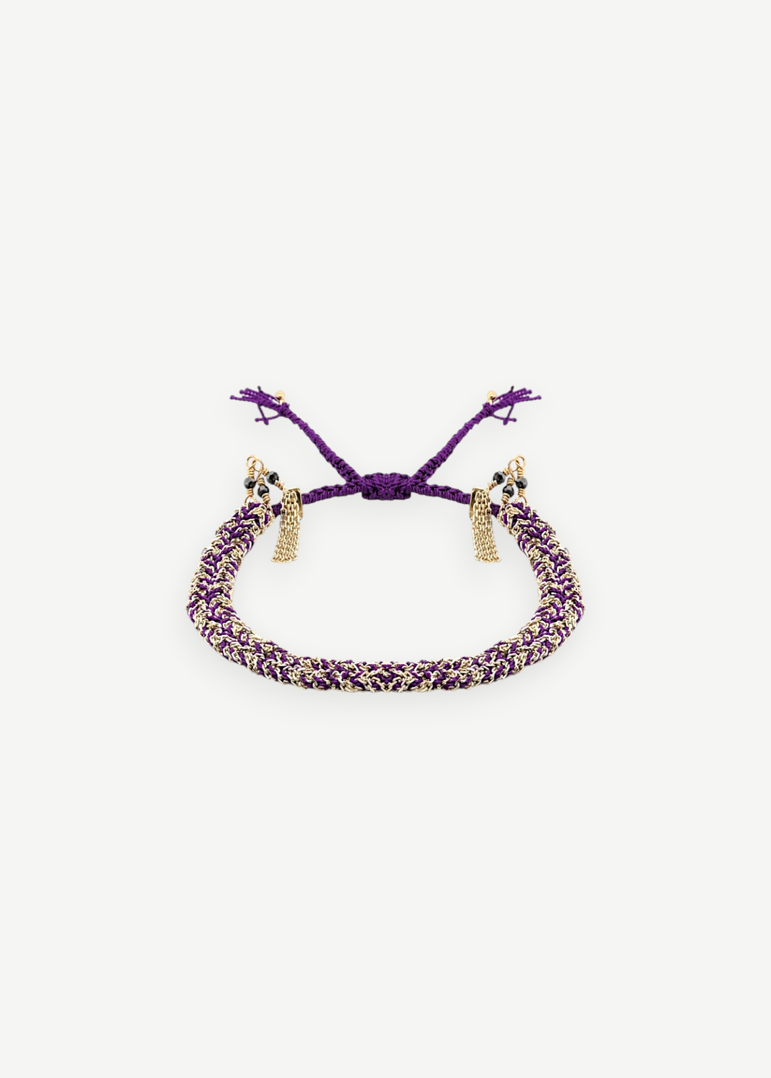 KABE SHOP INC N° 183 braided bracelet featuring purple cord woven with gold metallic thread and delicate tassels.
