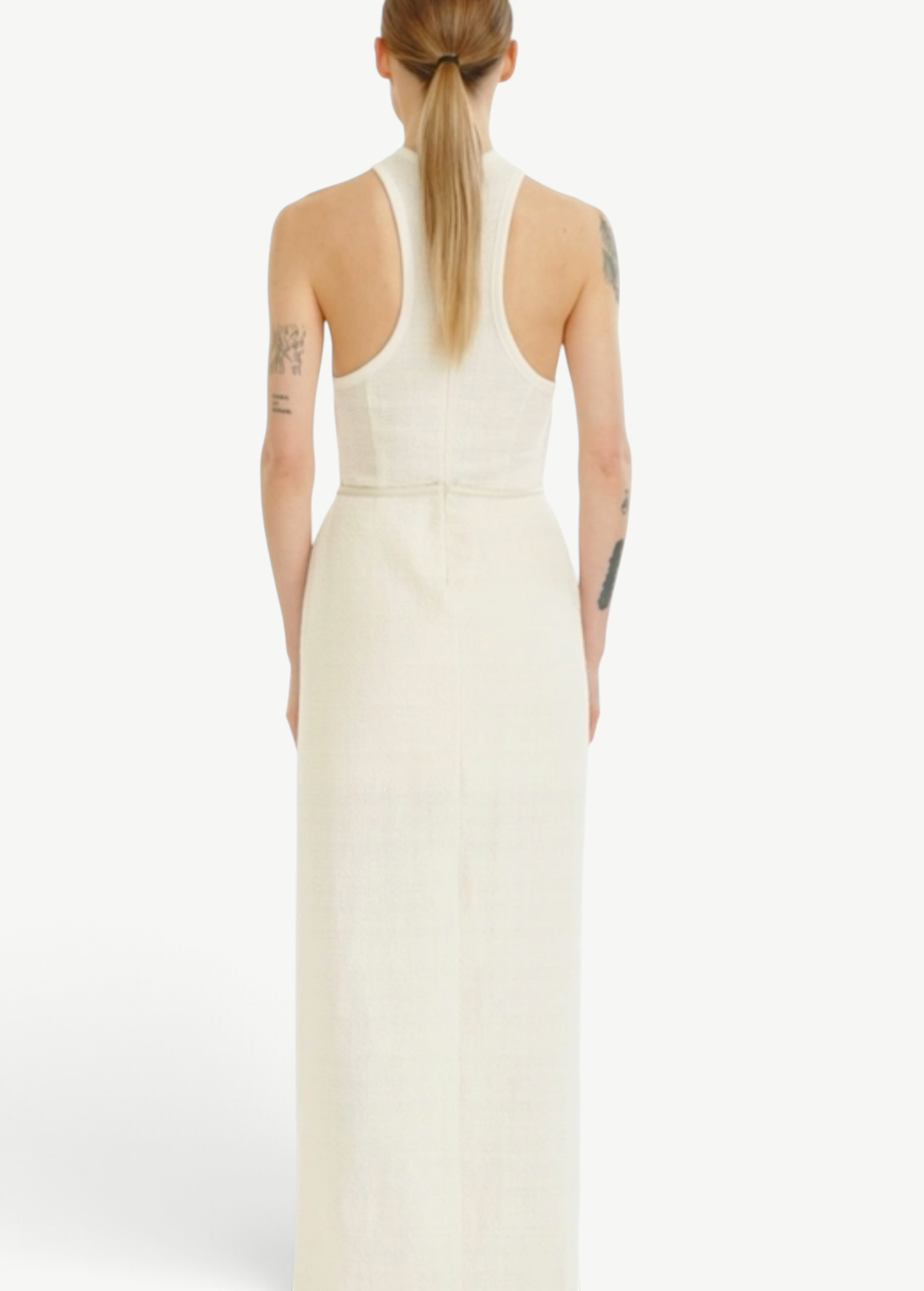 Back view of a woman wearing a KABE SHOP INC Rayen dress in cream with a racerback design and structured silhouette.