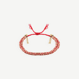 KABE SHOP INC N° 183 braided bracelet featuring red cord and gold-tone metallic threads with adjustable tassel ends.