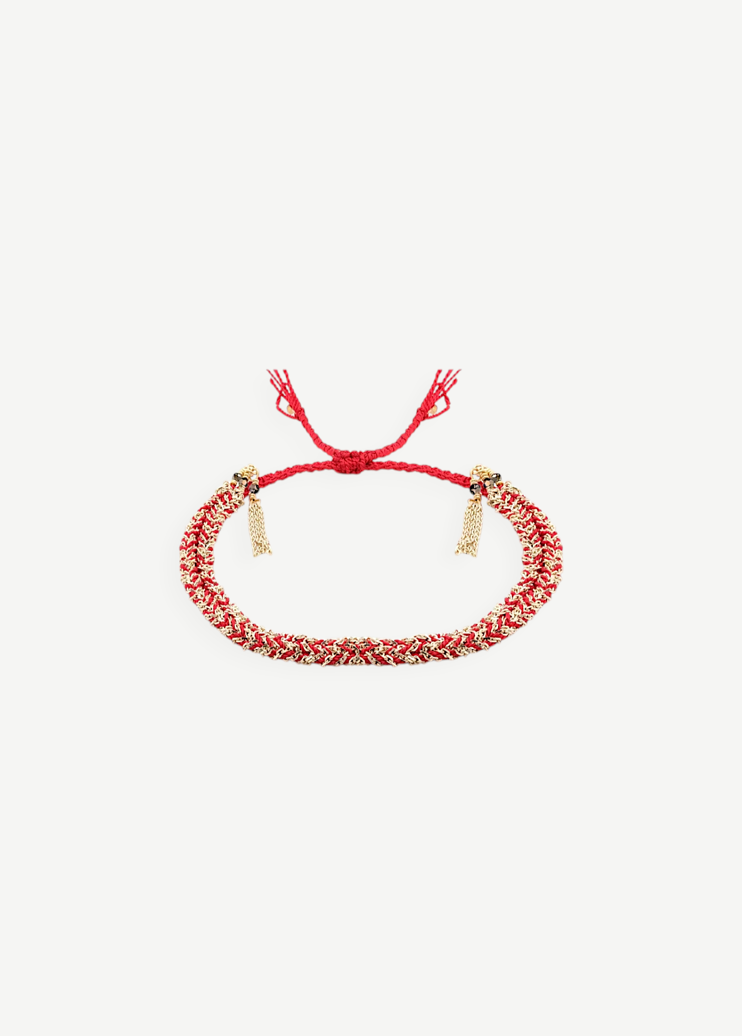 KABE SHOP INC N° 183 braided bracelet featuring red cord and gold-tone metallic threads with adjustable tassel ends.