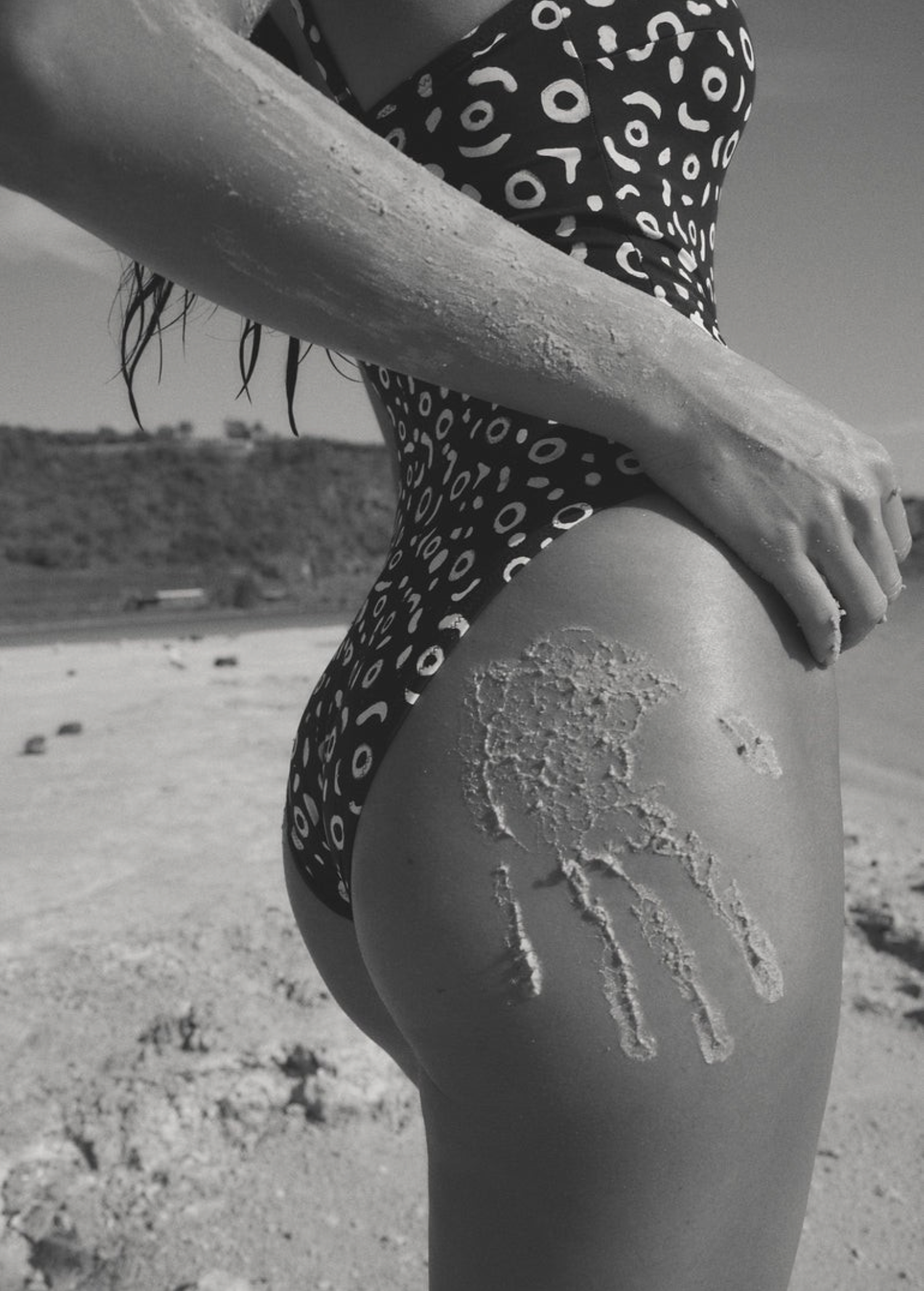 KABE SHOP INC Regatta one piece swimsuit in black and white geometric print worn on a sandy beach