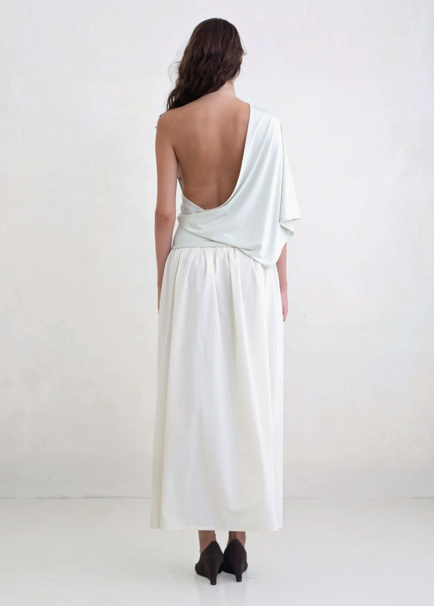 Back view of a woman wearing a KABE SHOP INC Rhea maxi skirt in white with an adjustable waistband