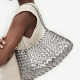 KABE SHOP INC Rosanna Bag in metallic silver handwoven buffalo leather worn over the shoulder by a model