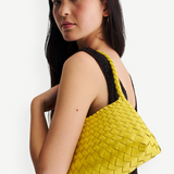KABE SHOP INC Rosanna Bag in bright yellow handwoven buffalo leather with a sleek shoulder silhouette on a model