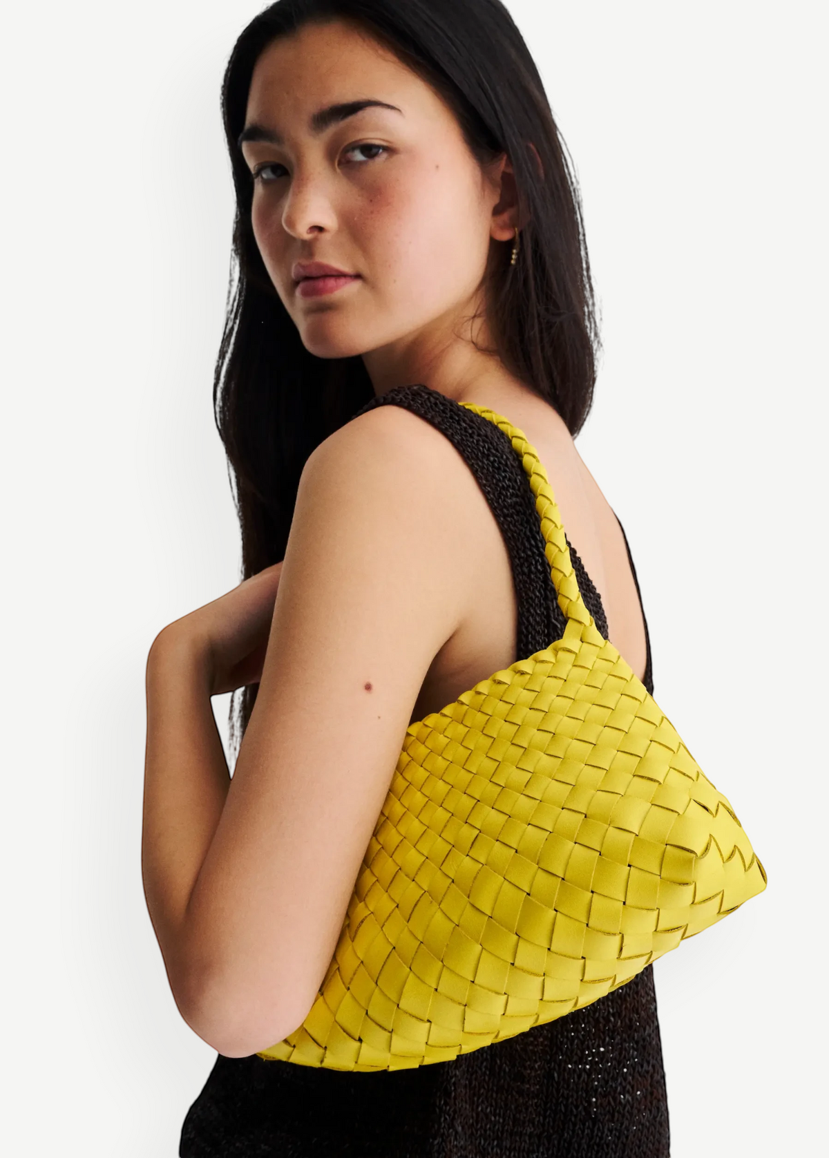KABE SHOP INC Rosanna Bag in bright yellow handwoven buffalo leather with a sleek shoulder silhouette on a model