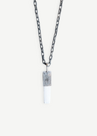KABE SHOP INC Selenite necklace featuring a white crystal pendant with a textured silver cap on a dark chain