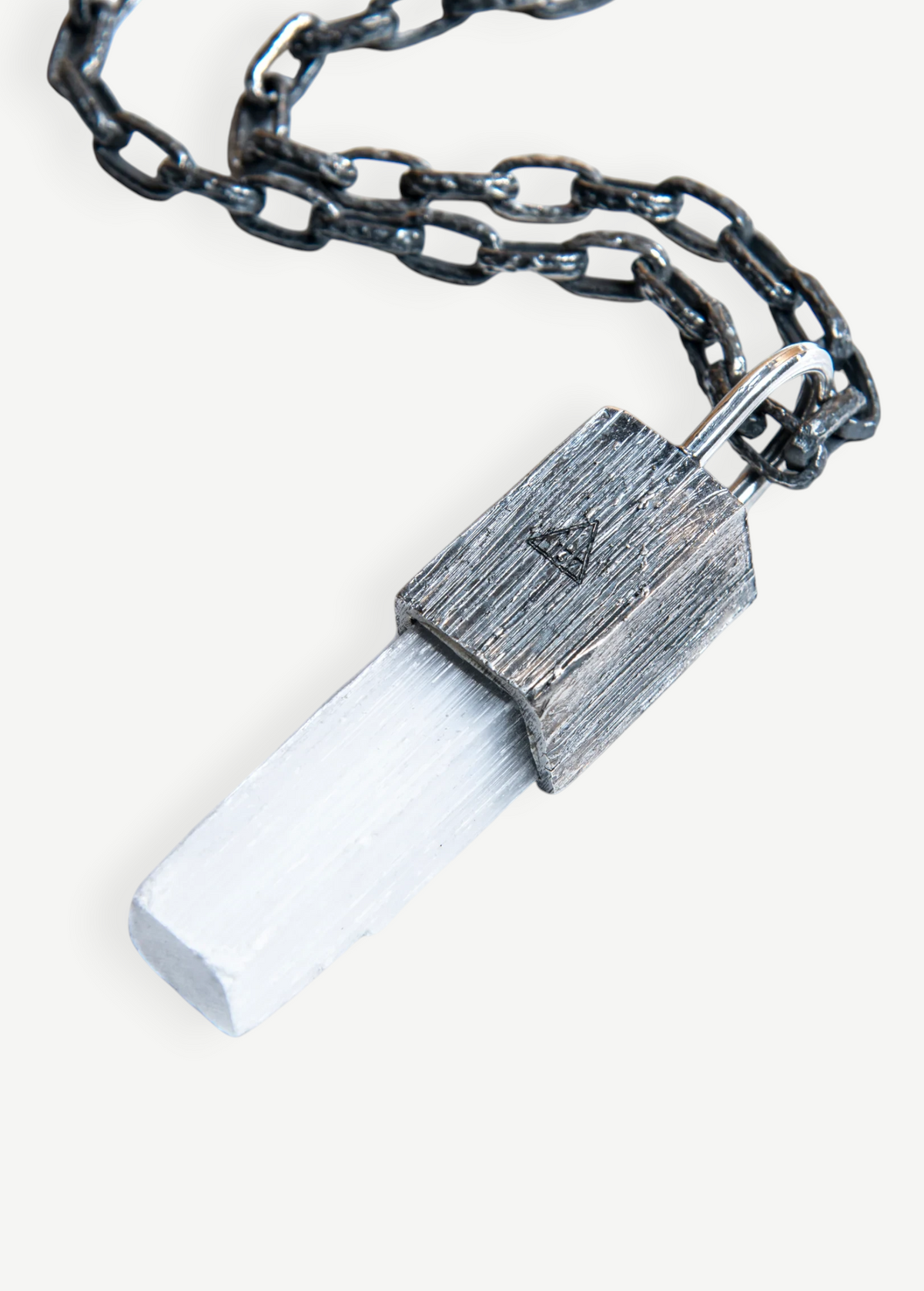 KABE SHOP INC selenite crystal pendant necklace with a textured oxidized silver padlock setting and heavy chain