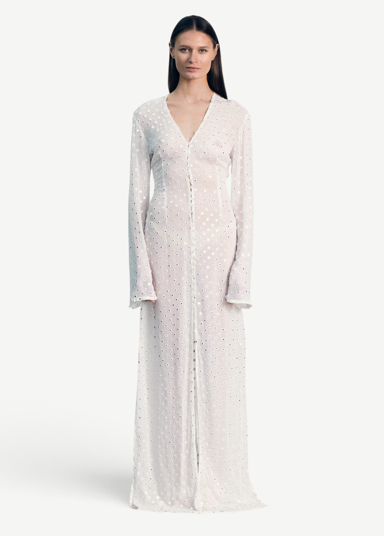 Model wearing a KABE SHOP INC sheer white long-sleeve Mirror Dress with delicate silver embellishments