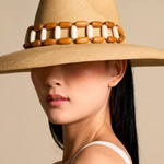 KABE SHOP INC Sine wide brim straw hat with decorative wooden and white bead band worn by a woman