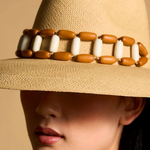 KABE SHOP INC Sine wide brim straw hat in beige with a decorative brown and white beaded band on a model