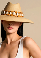 KABE SHOP INC Sine wide brim straw hat with a decorative wooden bead band worn by a woman in a white tank top