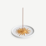 KABE SHOP INC Soleil porcelain incense holder with a gold hand-painted sun motif on a white circular base