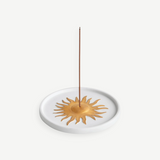 KABE SHOP INC Soleil porcelain incense holder with a gold hand-painted sun motif on a white circular base