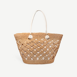 KABE SHOP INC handcrafted Toquilla straw beach basket bag with an open weave design and white leather handles.