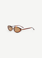 KABE Ambra oval sunglasses featuring a tortoiseshell frame, gold-tone accents, and brown gradient lenses.