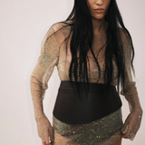 KABE SHOP INC Undone Corset Belt in black calfskin worn by a model over a shimmering metallic mesh dress
