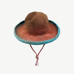 KABE SHOP INC Wika crochet hat featuring a vibrant tie-dye gradient in brown, orange, and blue with a chin strap.
