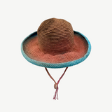 KABE SHOP INC Wika crochet hat featuring a vibrant tie-dye gradient in brown, orange, and blue with a chin strap.