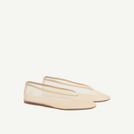 A pair of beige Luna Slipper Shoes, featuring a minimalist design with a slightly pointed toe, thin soles, and a low-cut silhouette crafted from glossy patent leather, displayed on a white background.