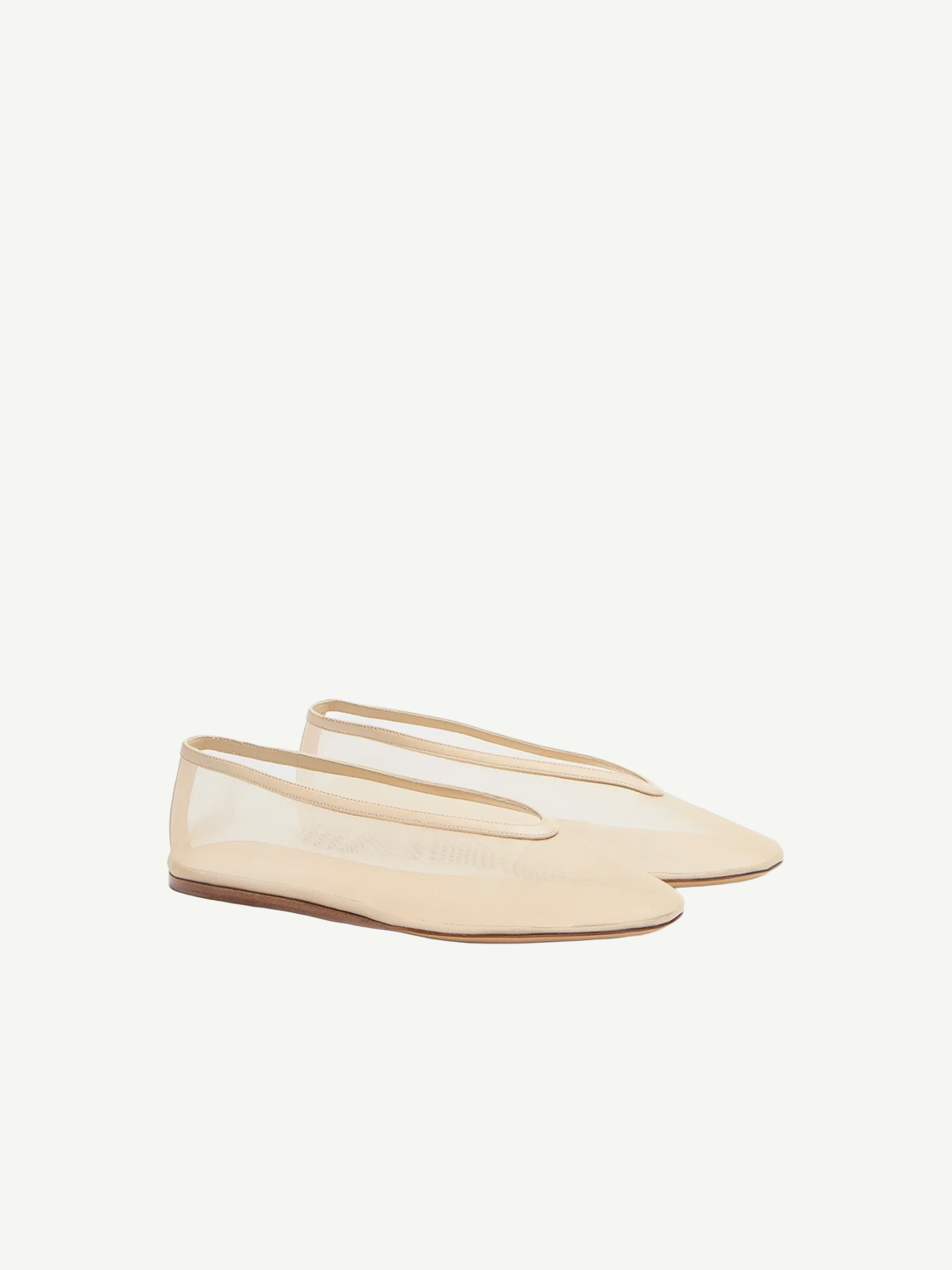 A pair of beige Luna Slipper Shoes, featuring a minimalist design with a slightly pointed toe, thin soles, and a low-cut silhouette crafted from glossy patent leather, displayed on a white background.