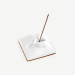 KABE SHOP INC Oh Mon Dieu! white porcelain incense holder featuring a sculptural pair of lips with a burning stick.