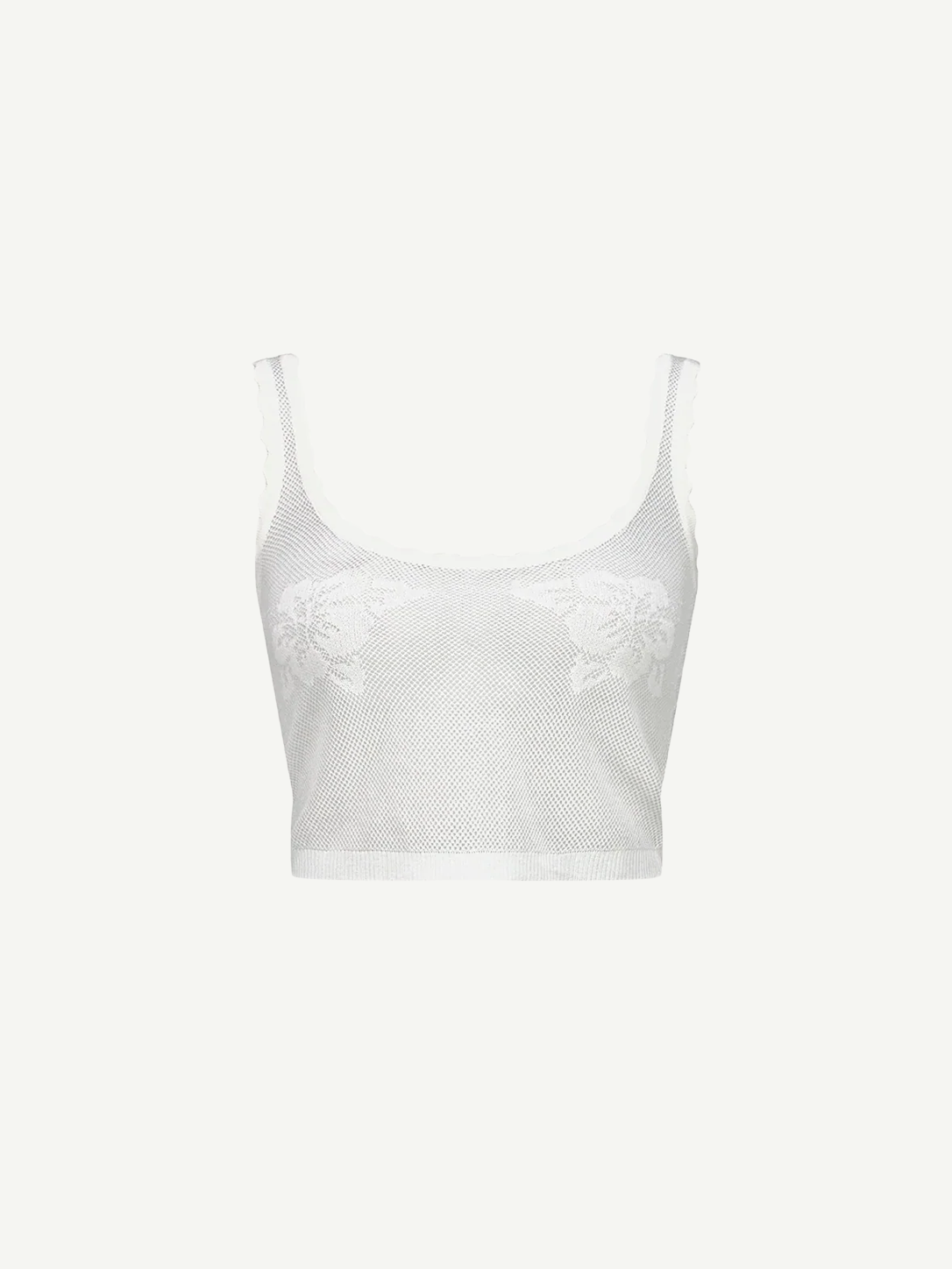 The Emma Knit Top is a sheer white mesh crop top featuring wide straps, a scoop neckline, and delicate hibiscus floral lace details on the front, displayed against a plain white background.