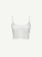 The Emma Knit Top is a sheer white mesh crop top featuring wide straps, a scoop neckline, and delicate hibiscus floral lace details on the front, displayed against a plain white background.