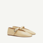 A pair of Stella Slipper Leather Shoes in beige custard leather, designed as Mary Jane flats with an elegant buckle on a thin strap, displayed against a plain white background.