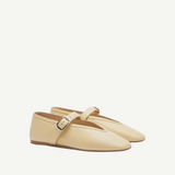 A pair of Stella Slipper Leather Shoes in beige custard leather, designed as Mary Jane flats with an elegant buckle on a thin strap, displayed against a plain white background.
