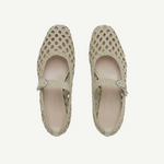 Top view of a pair of Mary Jane Woven Leather Shoes in beige, crafted from handwoven goatskin with a closed toe and an instep strap featuring buckle fastening, displayed against a plain white background.