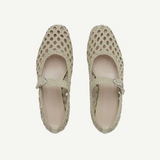 Top view of a pair of Mary Jane Woven Leather Shoes in beige, crafted from handwoven goatskin with a closed toe and an instep strap featuring buckle fastening, displayed against a plain white background.