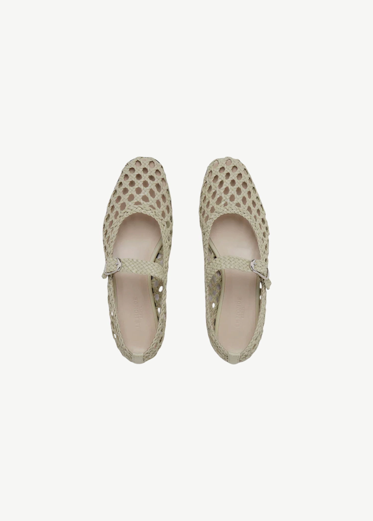 Top view of a pair of Mary Jane Woven Leather Shoes in beige, crafted from handwoven goatskin with a closed toe and an instep strap featuring buckle fastening, displayed against a plain white background.