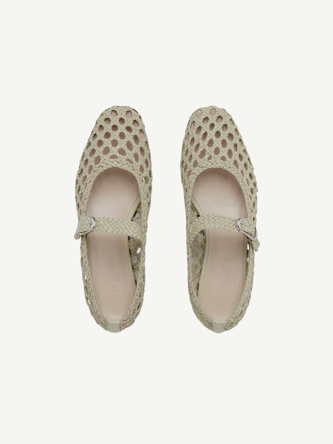 Top view of a pair of Mary Jane Woven Leather Shoes in beige, crafted from handwoven goatskin with a closed toe and an instep strap featuring buckle fastening, displayed against a plain white background.