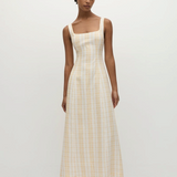 Model wearing a KABE SHOP INC Lenice midi dress in yellow and white plaid linen with a square neckline