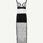 La Femme Dress: This black-and-white sleeveless dress features thin straps and bold circular patterns on the bodice, complemented by a solid black midsection. The skirt is crafted from crochet fabric with see-through diamond-patterned netting, creating an elegant yet modern look. Photographed against a plain white background.