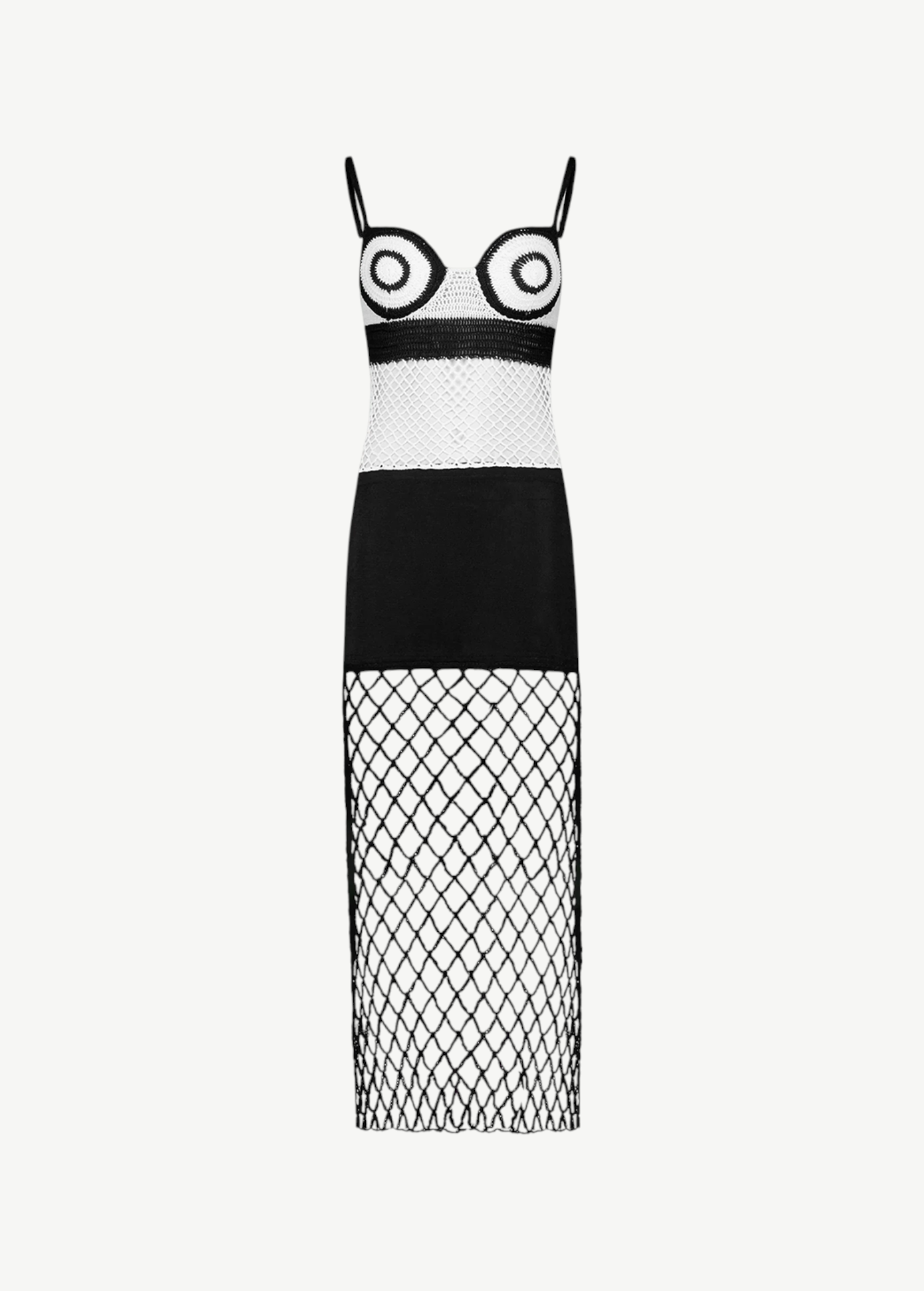 La Femme Dress: This black-and-white sleeveless dress features thin straps and bold circular patterns on the bodice, complemented by a solid black midsection. The skirt is crafted from crochet fabric with see-through diamond-patterned netting, creating an elegant yet modern look. Photographed against a plain white background.