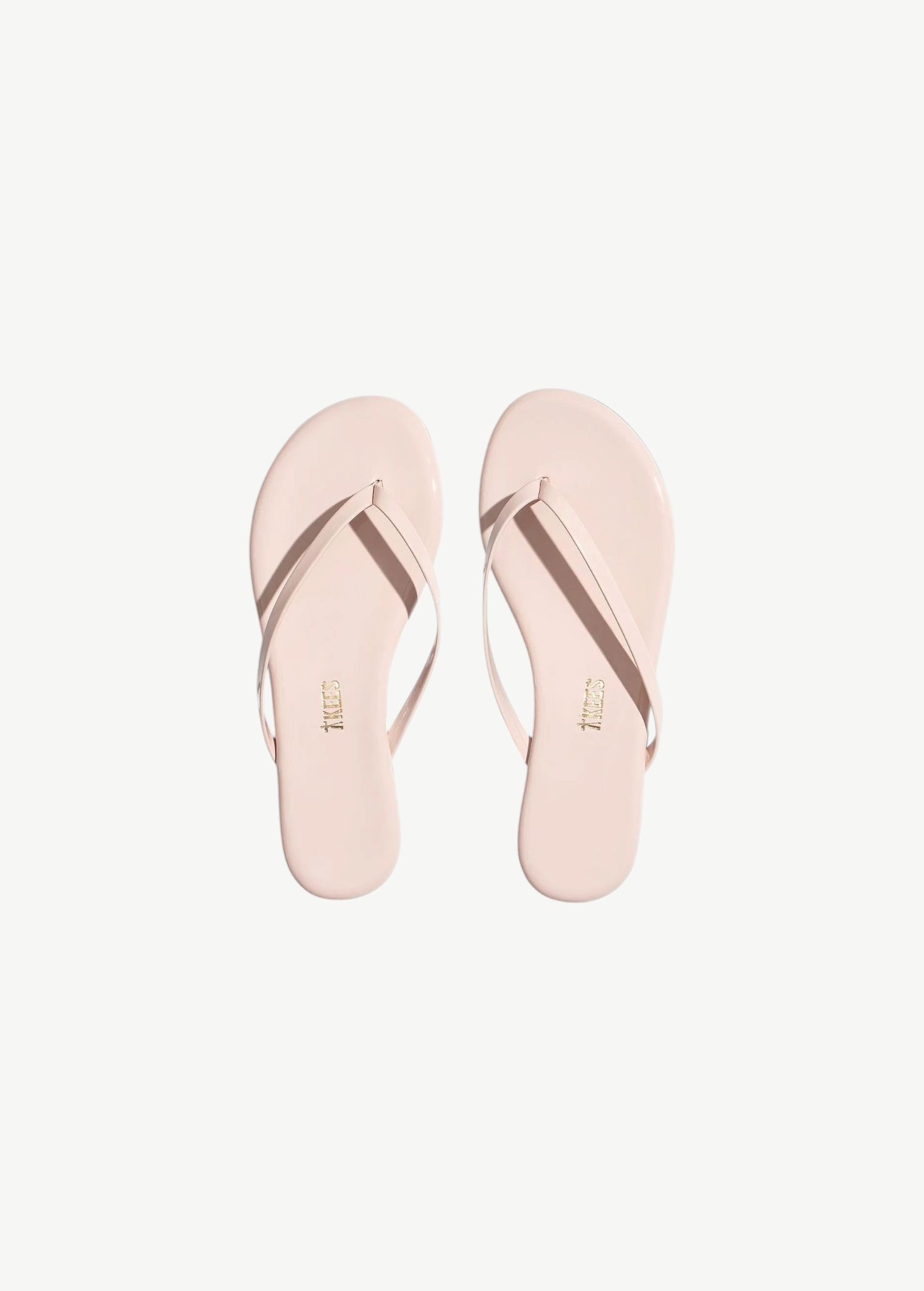 KABE SHOP INC Lily Glosses pale pink patent leather flip flops with cushioned insoles and rubber outsoles.