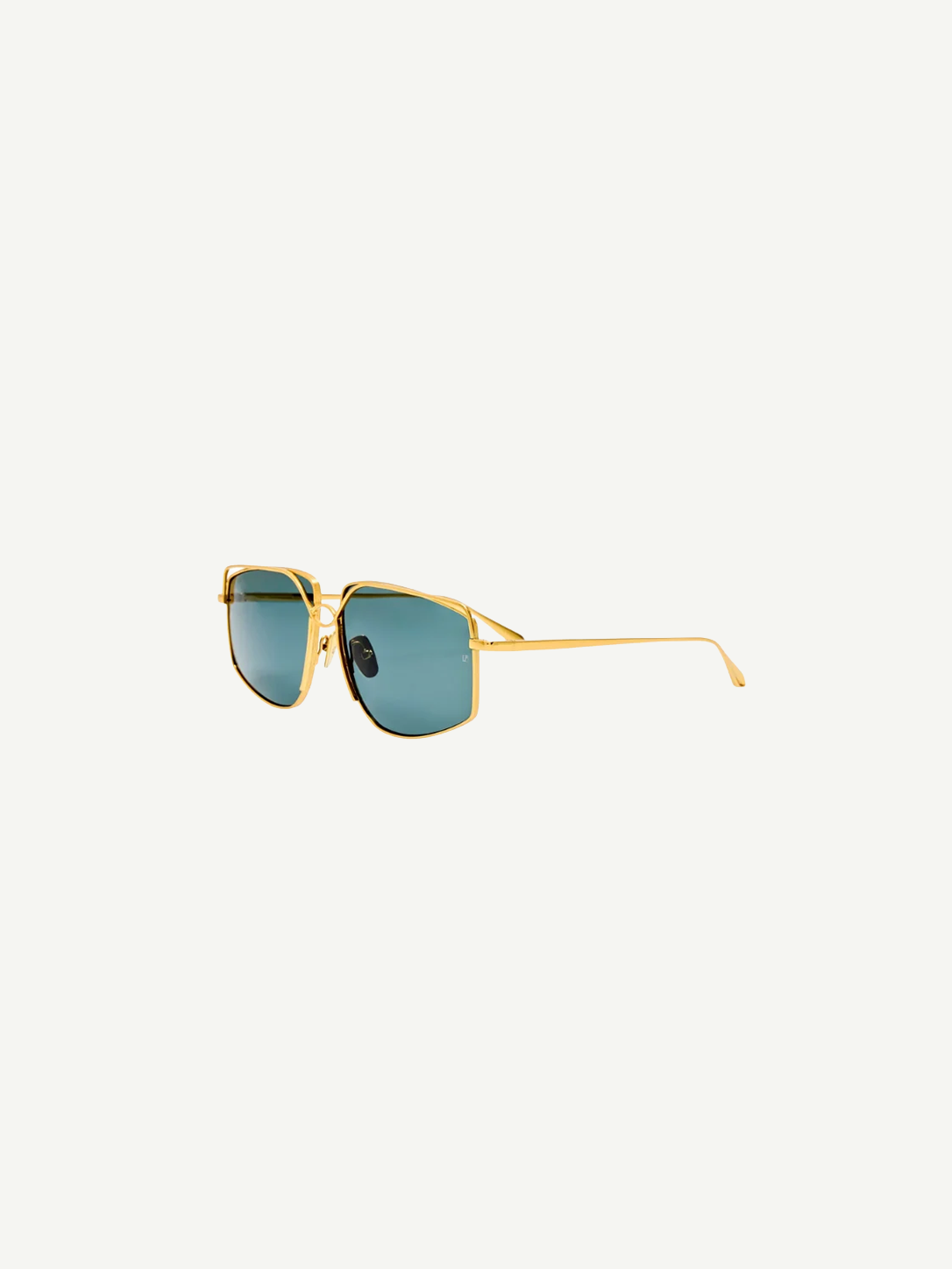 The Miranda Sunglasses feature an oversized, gold-plated frame and square blue-tinted lenses, displayed at an angle against a plain white background.