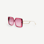 The Macy Sunglasses feature a square-shaped, oversized frame crafted from luxurious Italian acetate in bold pink, with light pink gradient lenses and elegant gold-plated temples and thin arms, showcased on a white background.
