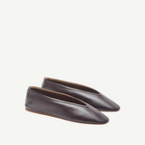 A pair of Luna Slipper Shoes in dark brown leather, featuring a minimalist design with subtle leather detailing and almond-shaped toes, displayed against a plain white background.